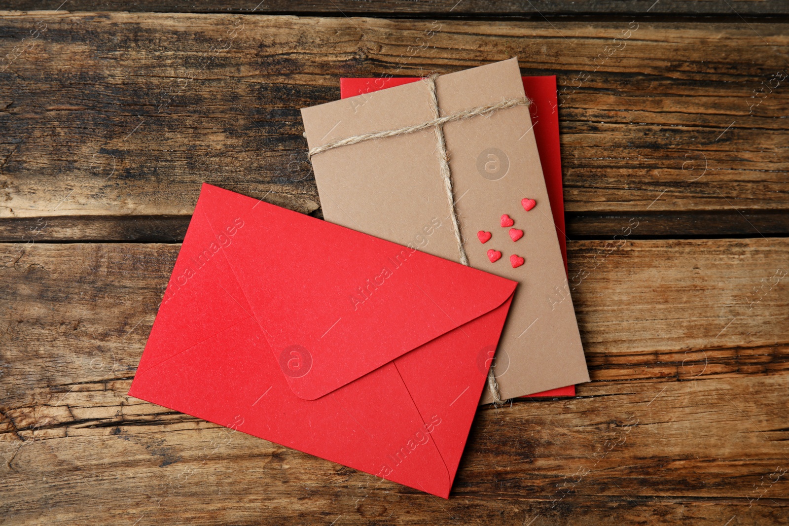 Photo of Envelopes on wooden table, flat lay. Love letters