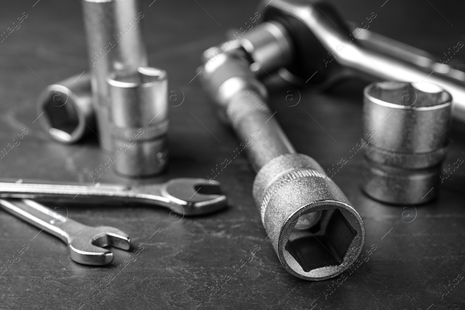 Photo of Auto mechanic's tools on grey background, closeup