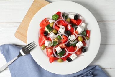 Photo of Plate with delicious salad on table, top view