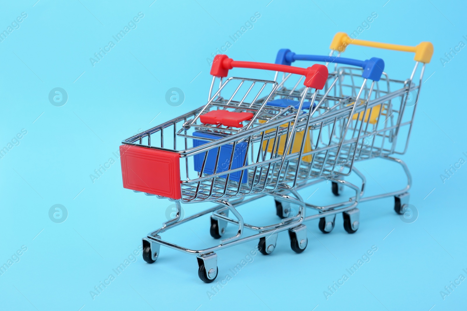 Photo of Empty shopping trolleys on color background. Space for text