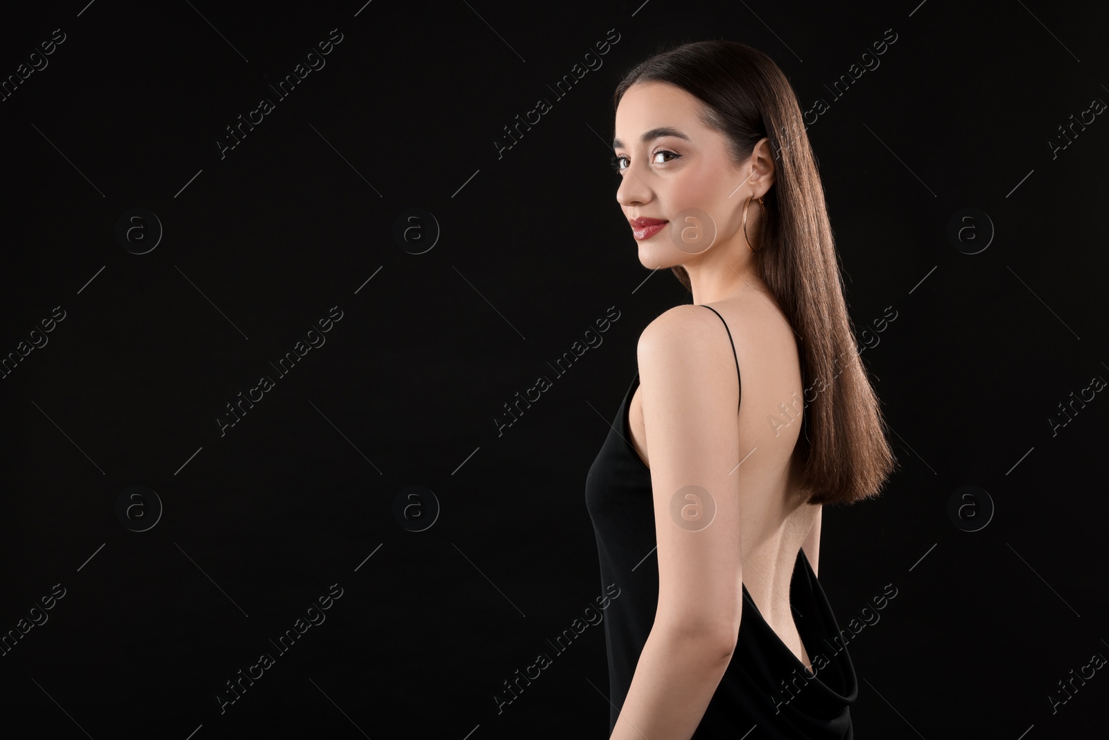 Photo of Beautiful young woman on black background, space for text