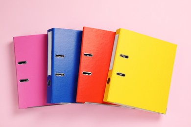 Photo of Office folders on pink background, flat lay