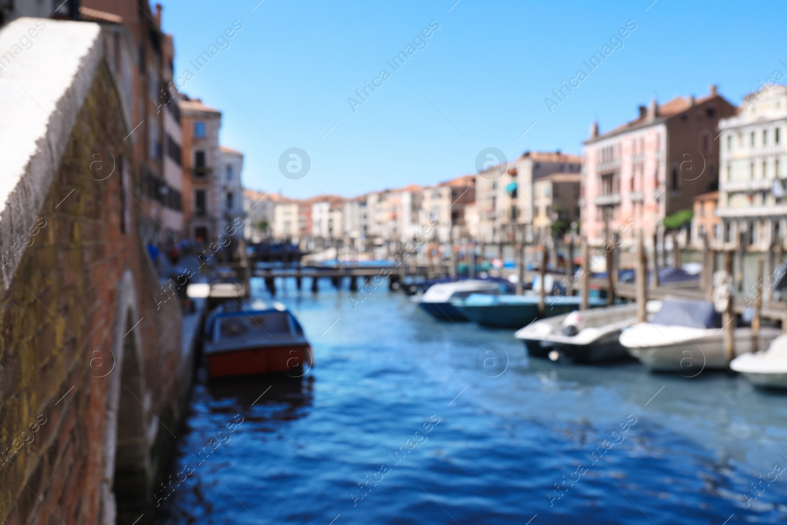 Photo of VENICE, ITALY - JUNE 13, 2019: Blurred view of Grand Canal with boats at pier