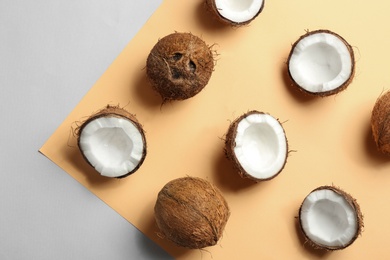 Photo of Flat lay composition with coconuts on color background