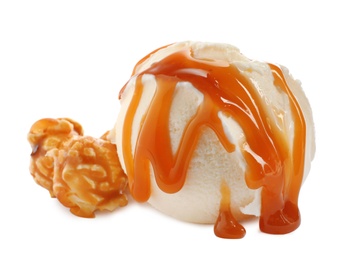 Photo of Scoop of delicious ice cream with caramel sauce and popcorn on white background