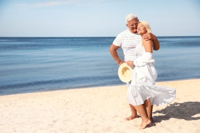 Mature couple spending time together on sea beach