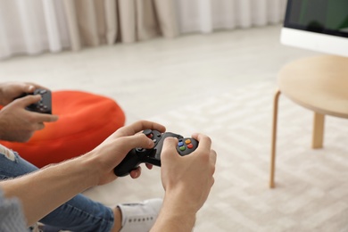Photo of Friends playing video games at home, closeup view