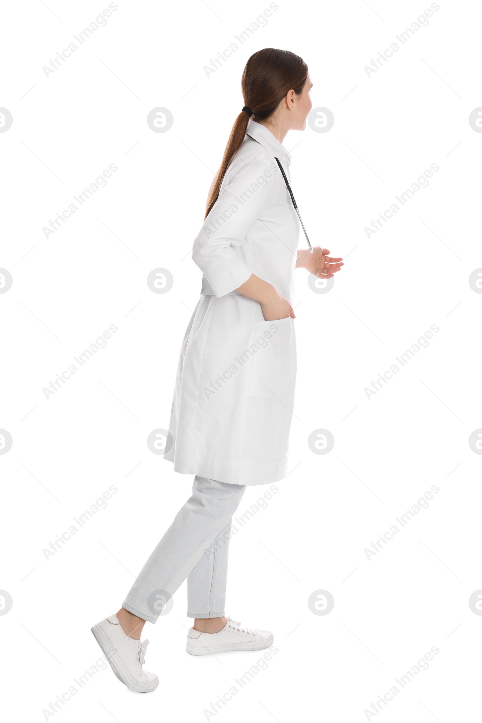 Photo of Doctor with stethoscope walking on white background