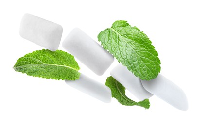 Image of Fresh mint leaves and chewing gum pads falling on white background