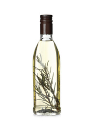 Photo of Cooking oil with rosemary in glass bottle isolated on white