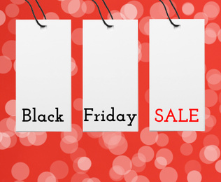 Image of Different tags on color background, flat lay. Black Friday 