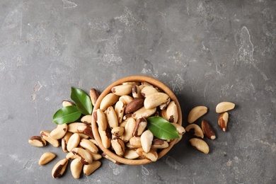Photo of Flat lay composition with Brazil nuts and space for text on grey background