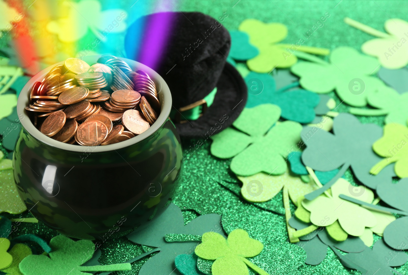 Image of Pot with gold coins, hat and clover leaves on table, space for text. St. Patrick's Day celebration