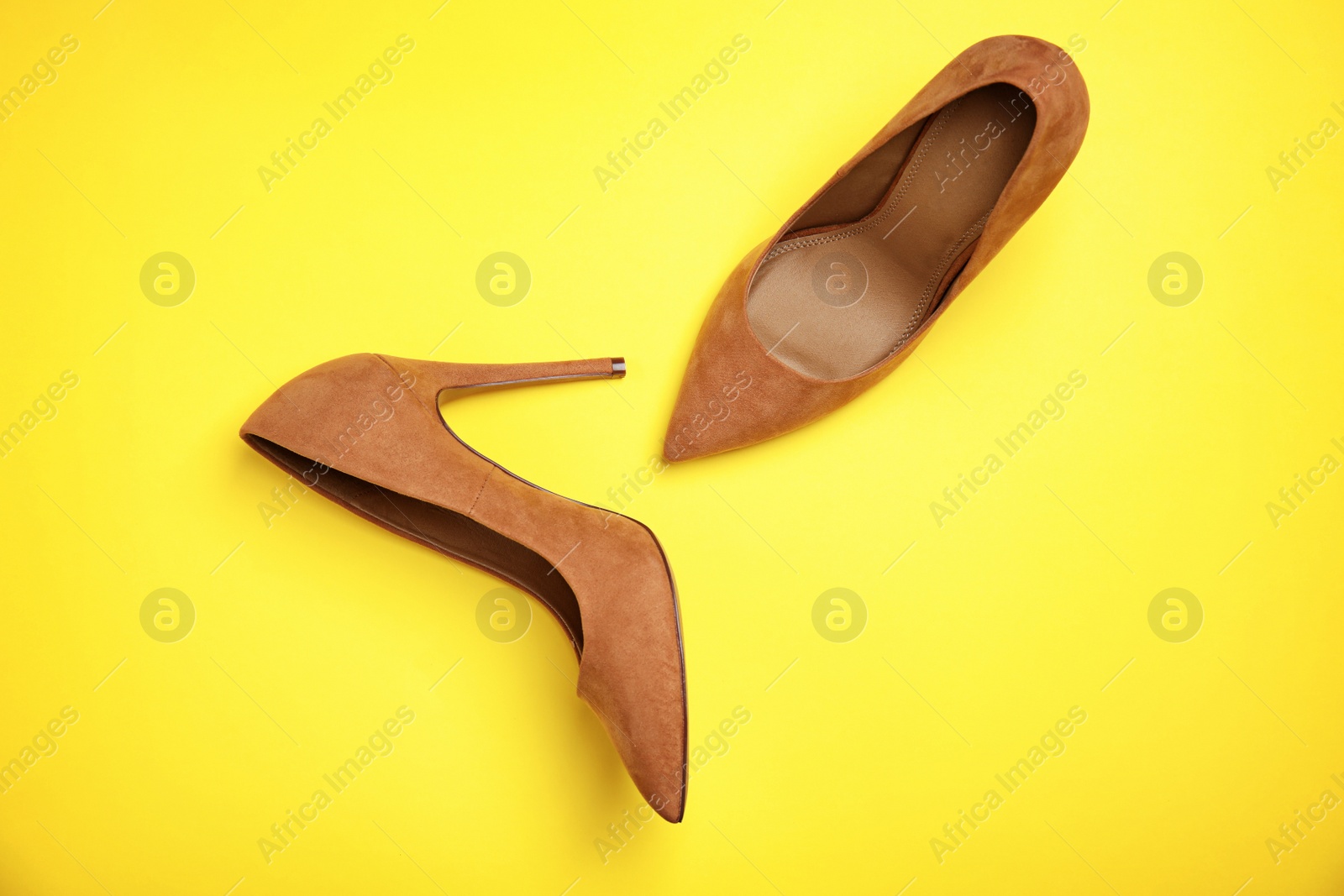 Photo of Pair of beautiful shoes on color background, top view