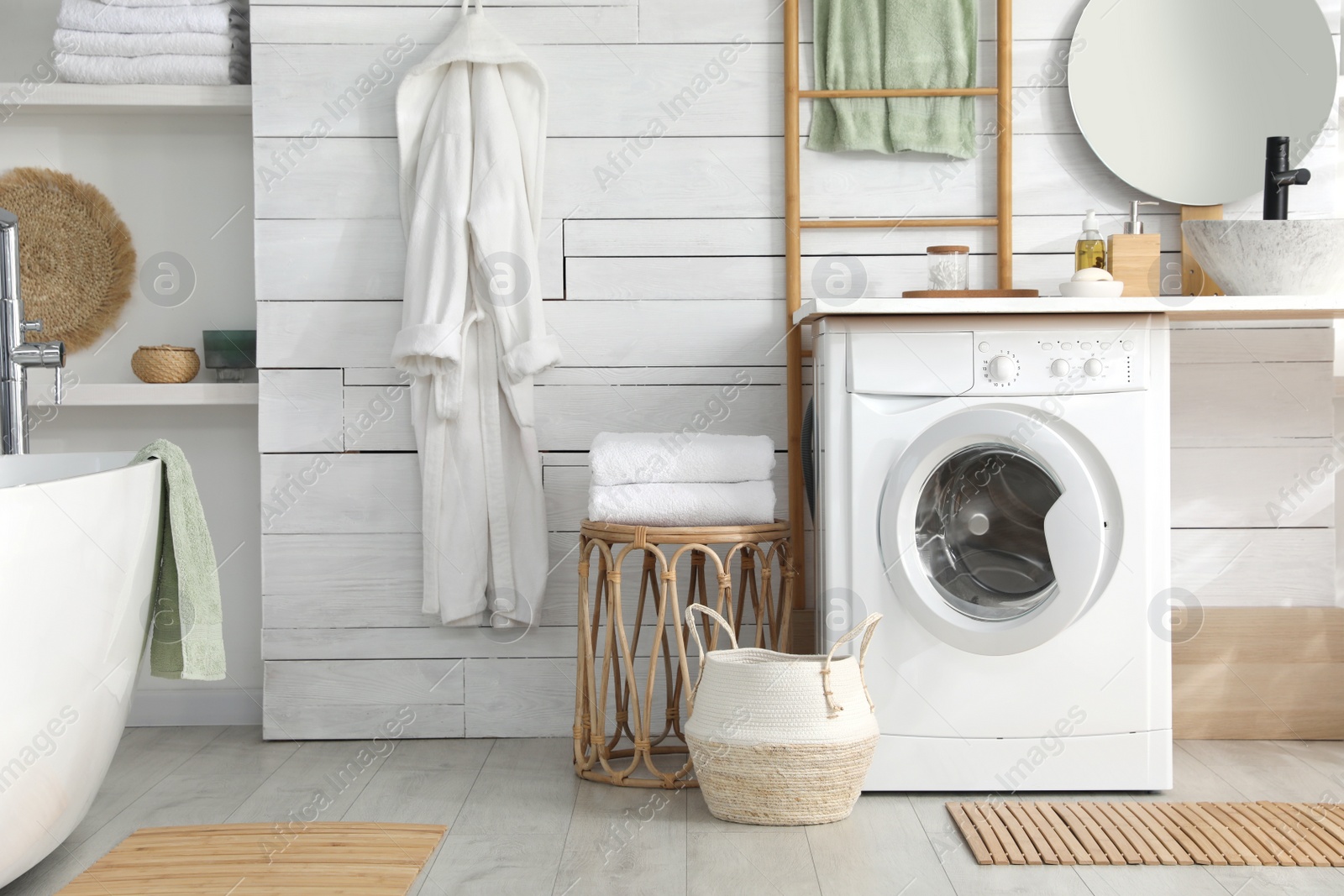 Photo of Stylish bathroom interior with modern washing machine