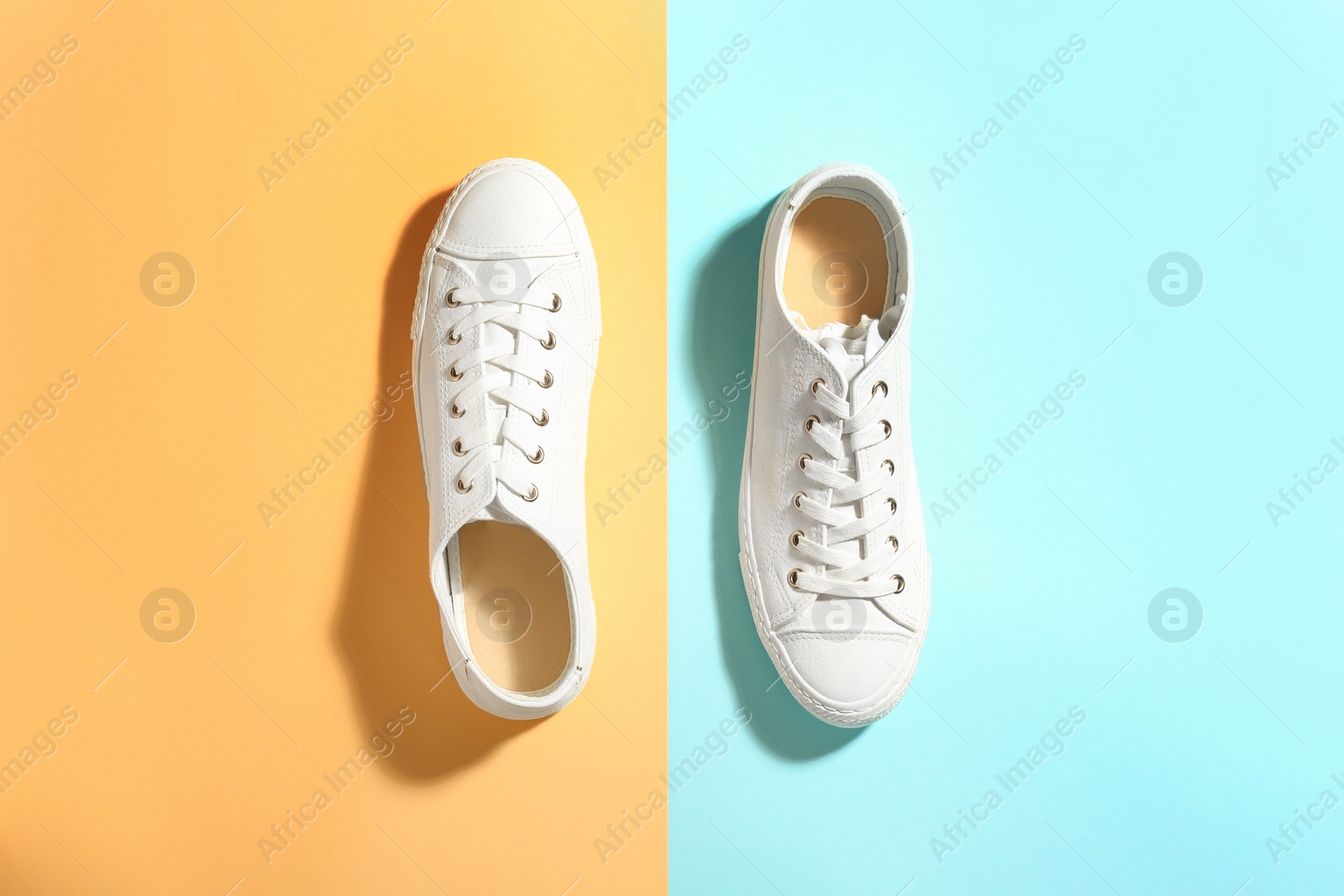 Photo of Pair of stylish sneakers on color background, top view