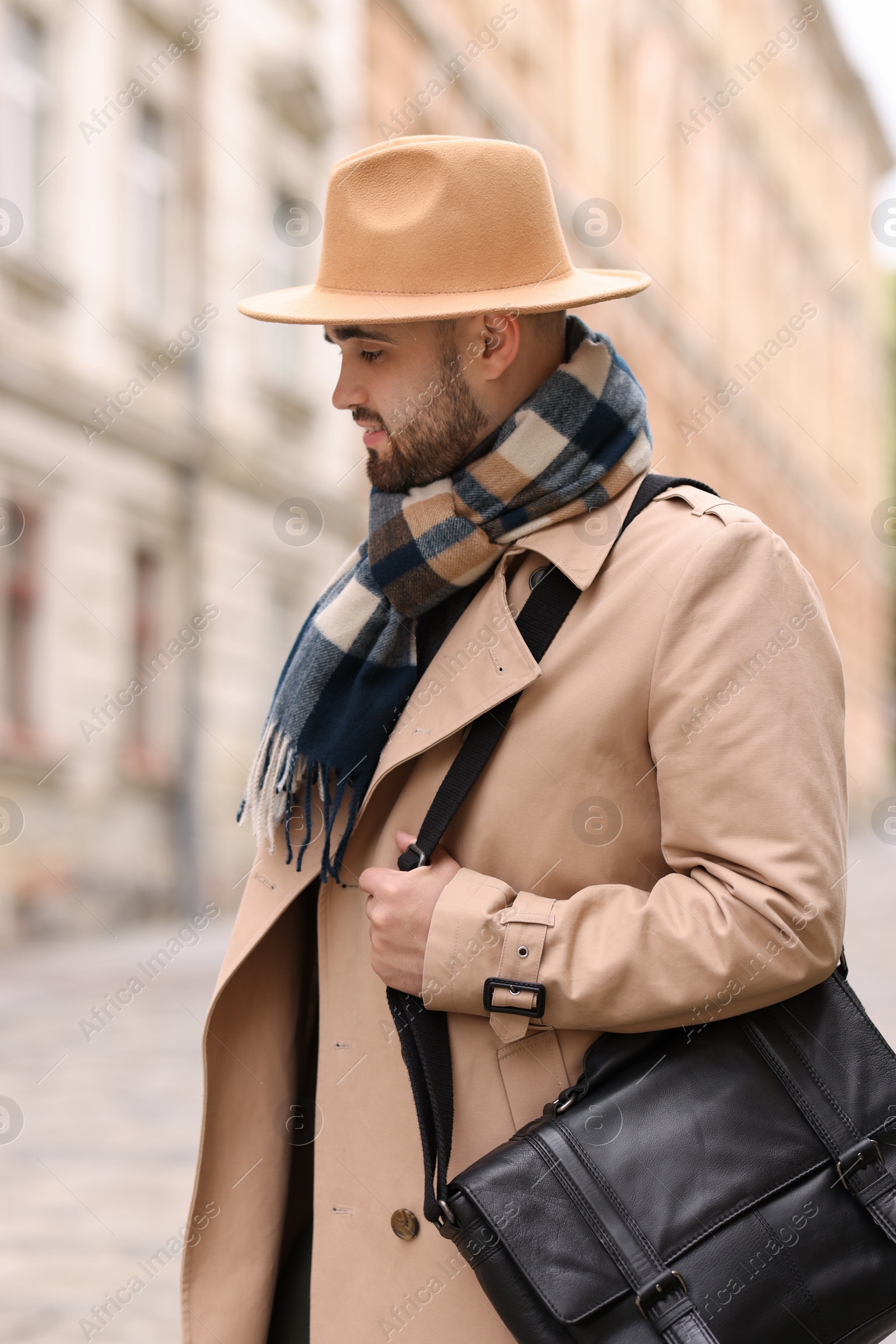 Photo of Handsome man in warm scarf on city street