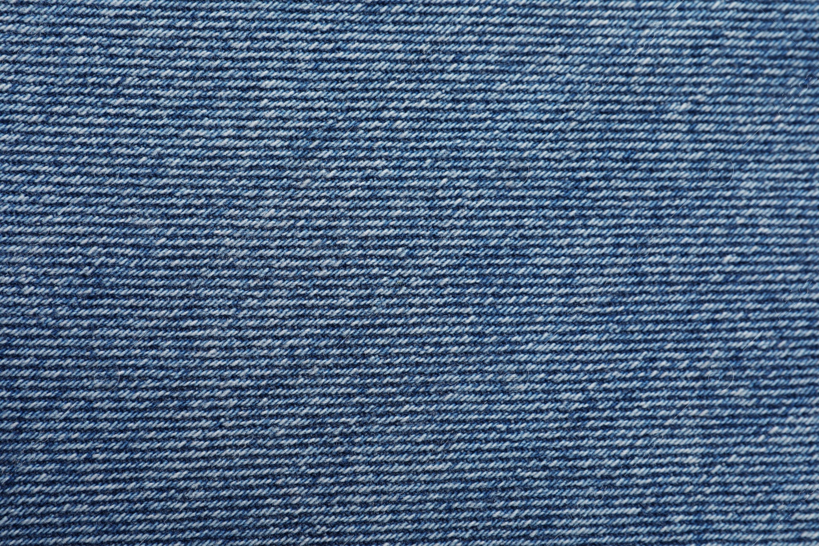 Photo of Texture of blue jeans as background, closeup