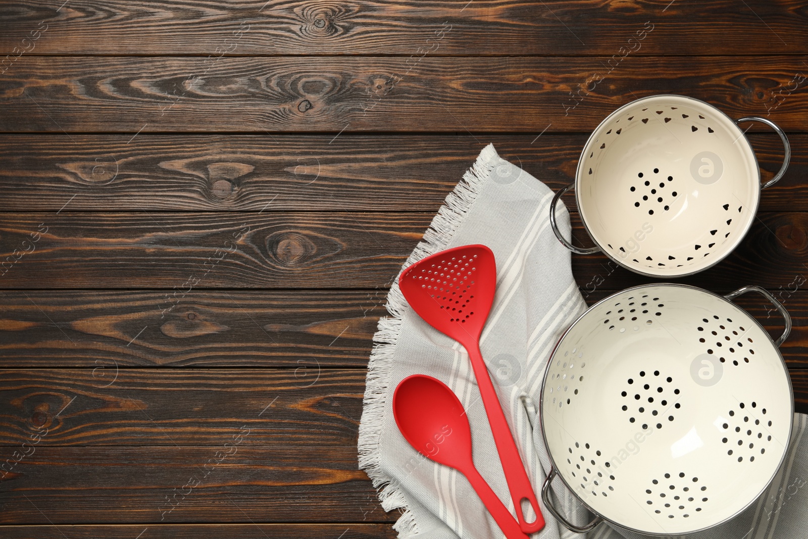 Photo of Set of modern cooking utensils on brown wooden table, flat lay. Space for text