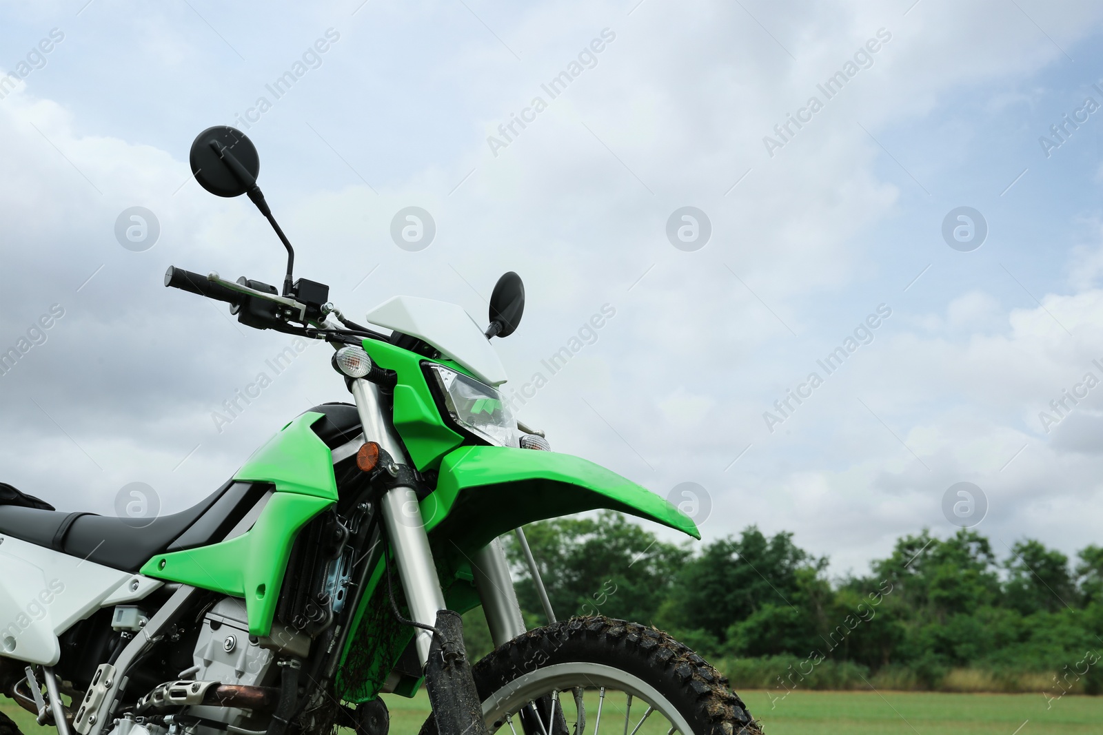 Photo of Stylish cross motorcycle outdoors, space for text