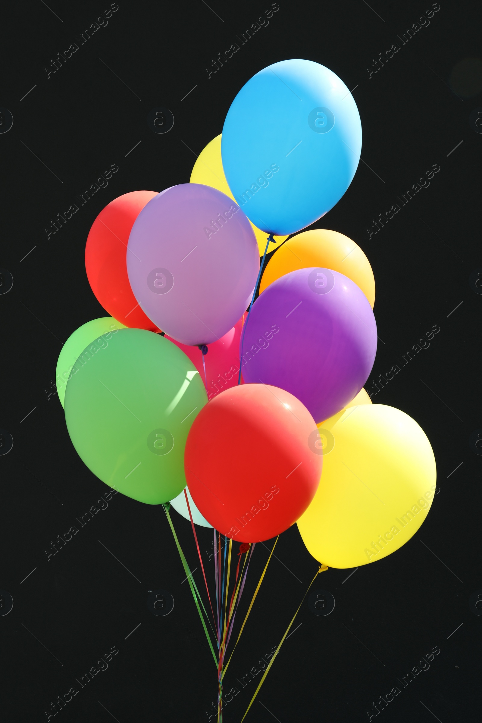 Photo of Bunch of colorful balloons on black background
