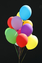 Bunch of colorful balloons on black background