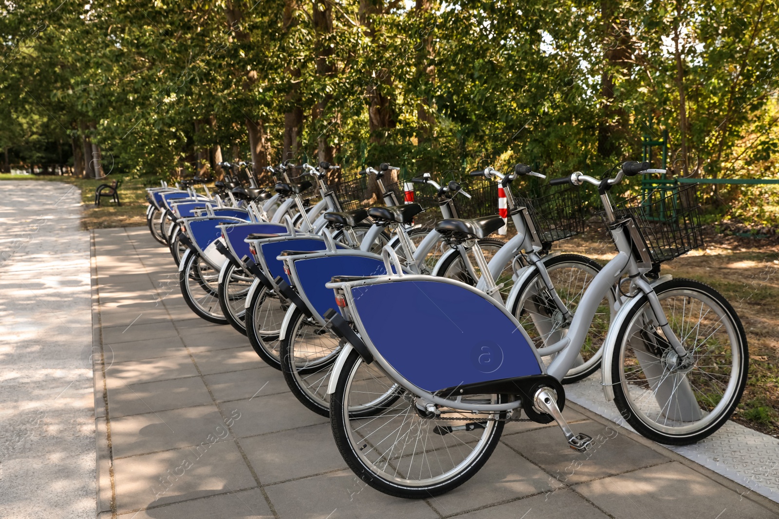 Photo of Parking rack with many bicycles outdoors. Bike rental