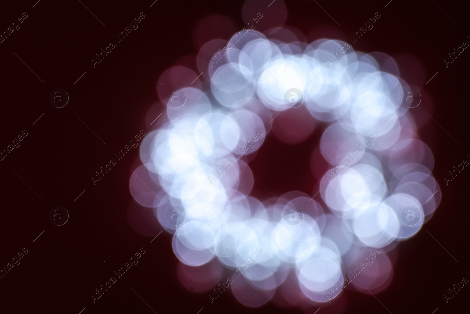 Photo of Blurred view of Christmas lights on dark background