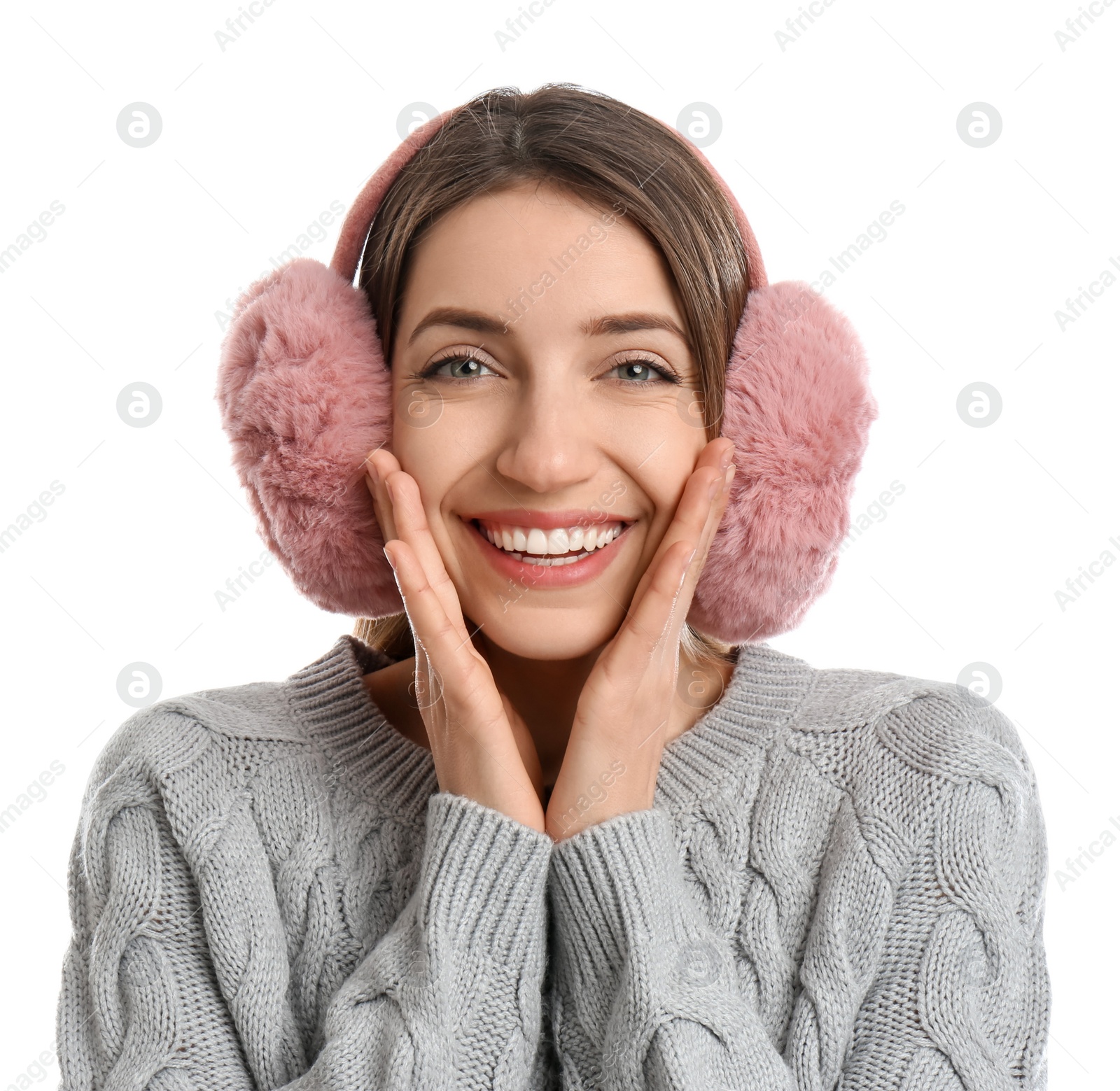 Photo of Happy woman wearing warm earmuffs on white background