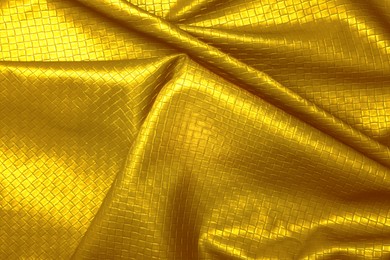 Texture of crumpled golden leather as background, closeup