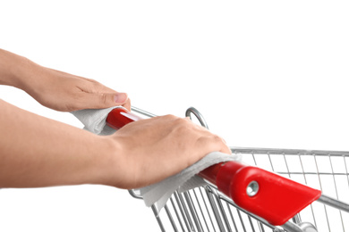 Photo of Woman holding shopping cart handle with tissue papers on white background, closeup