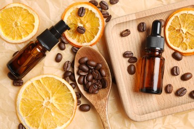 Photo of Flat lay composition with bottles of organic cosmetic products, coffee beans and dried orange slices on parchment paper