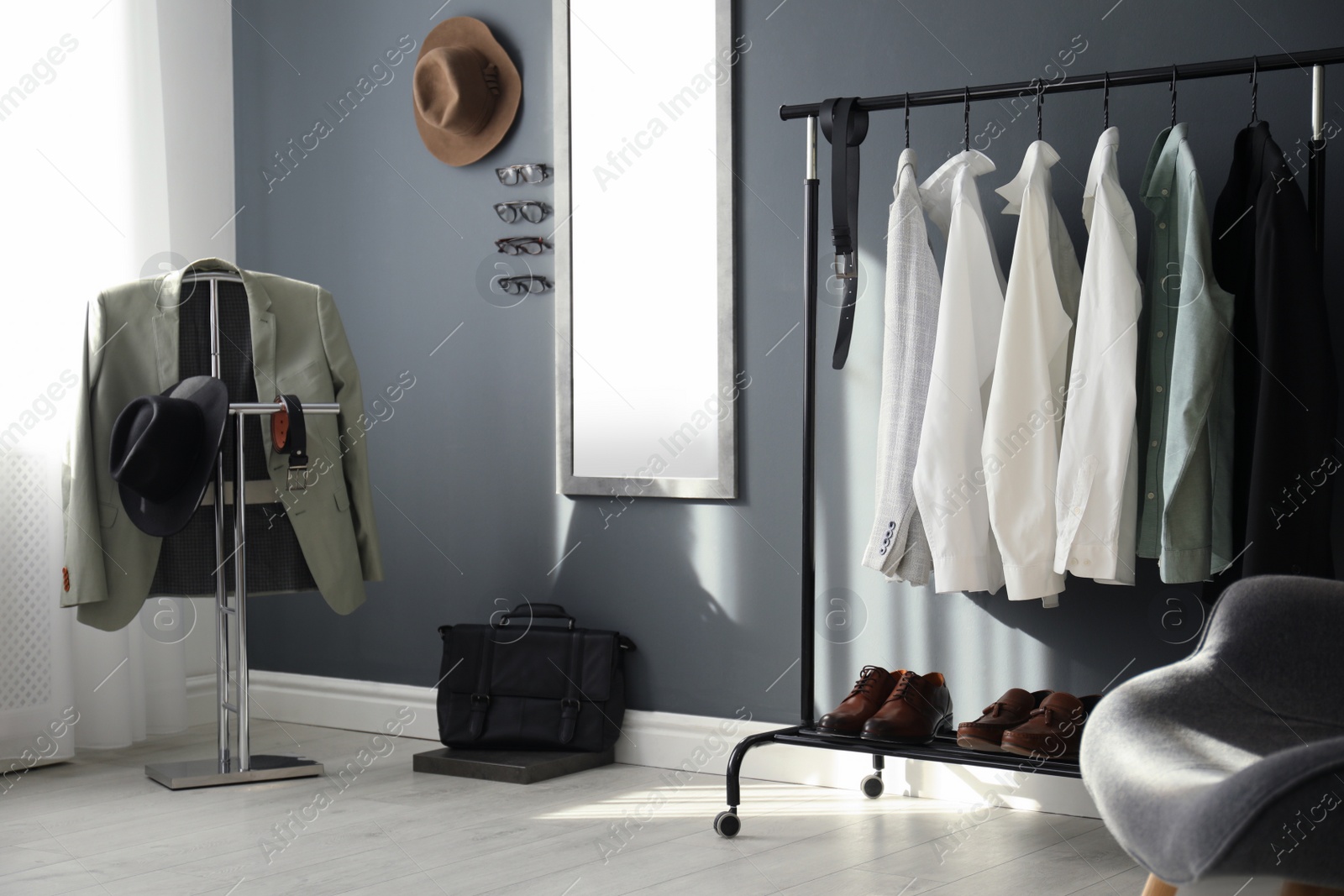 Photo of Dressing room interior with clothing rack and mirror