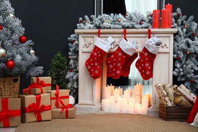 Photo of Fireplace with Christmas stockings in festive room interior