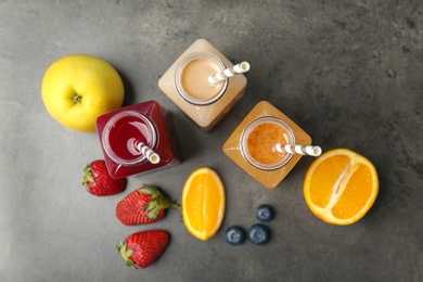 Photo of Flat lay composition with healthy detox smoothies and ingredients on grey background