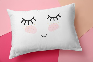 Image of Soft pillow with cute face on color background, top view
