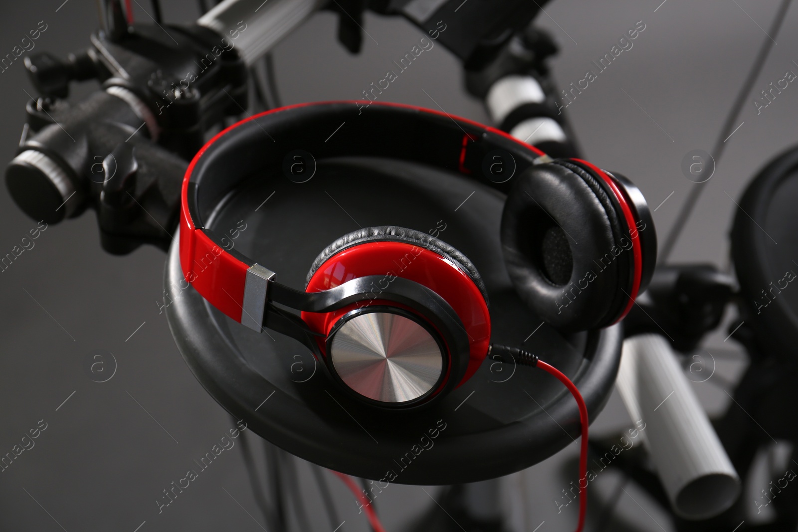 Photo of Modern electronic drum kit with headphones on grey background, closeup. Musical instrument