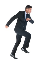 Photo of Businessman imitating stepping up on stairs against white background. Career ladder concept
