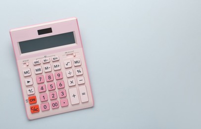 Pink calculator on light background, top view. Space for text