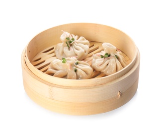 Bamboo steamer with tasty baozi dumplings on white background