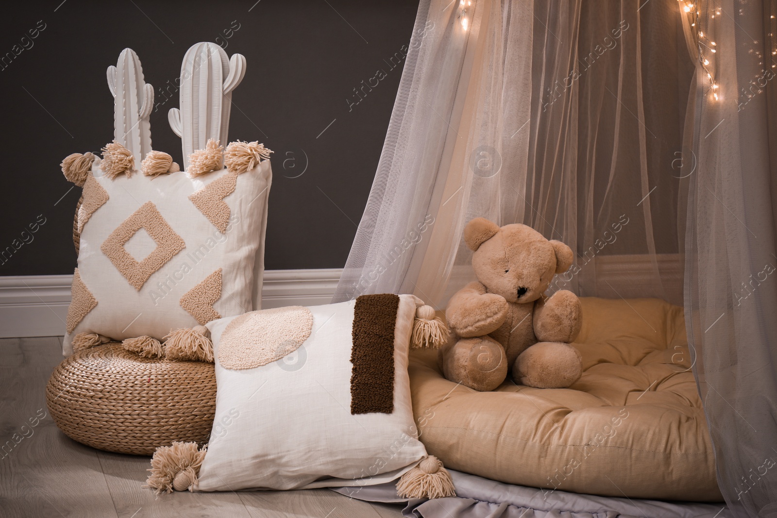 Photo of Cozy kids room interior with play tent and toys