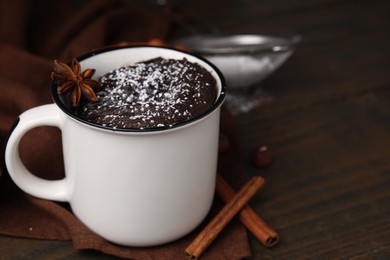 Photo of Tasty chocolate mug pie on wooden table, space for text. Microwave cake recipe