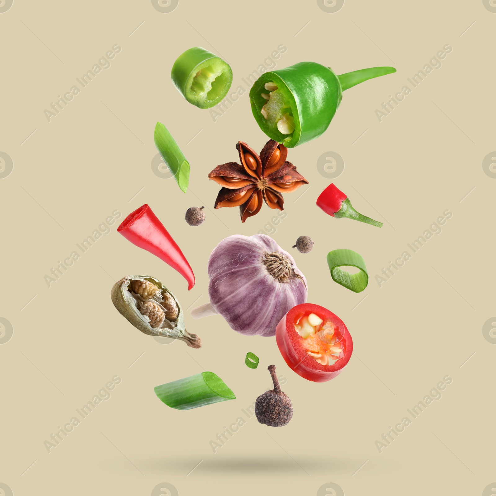 Image of Different spices falling on dark beige background