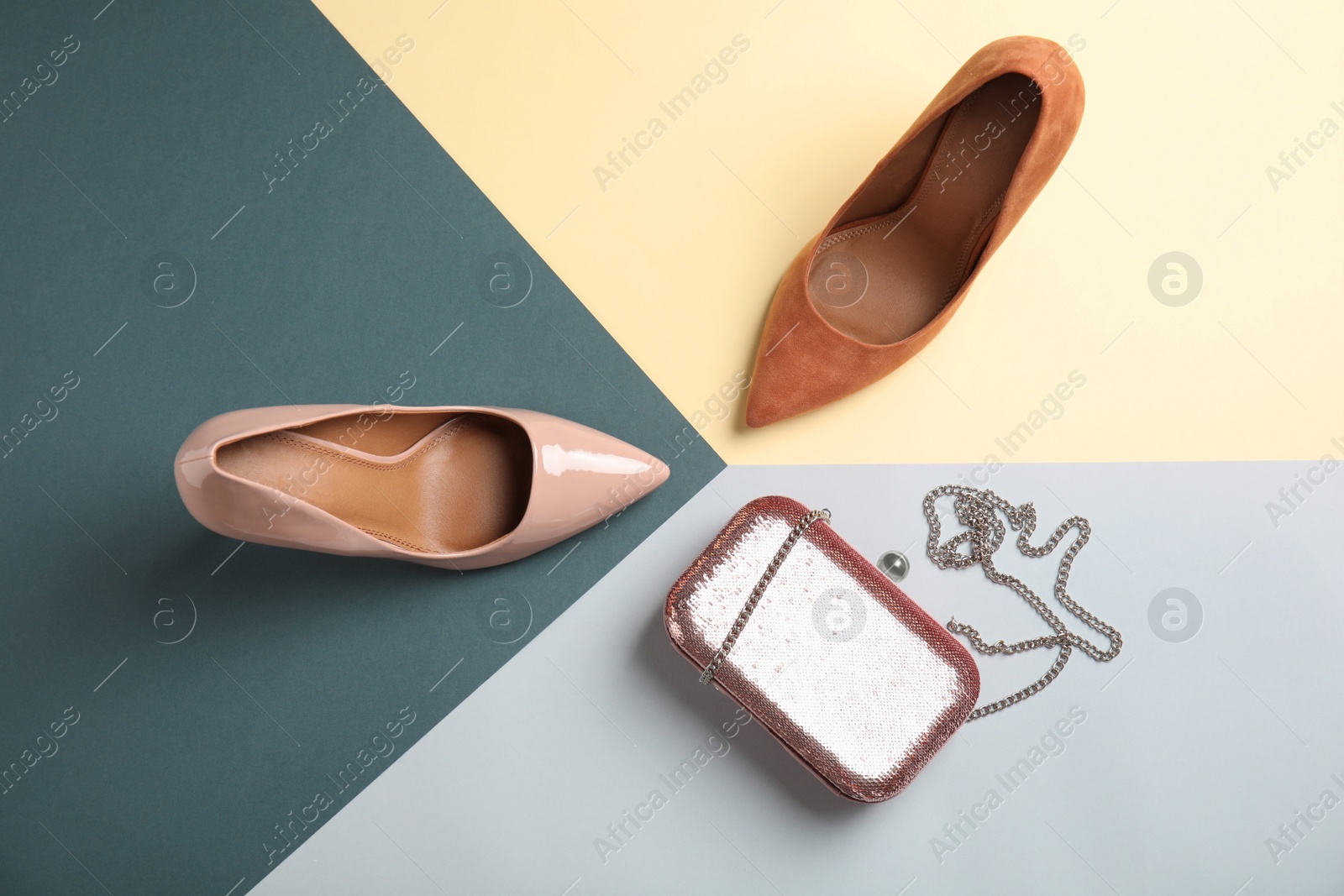 Photo of Flat lay composition with different shoes and small bag on color background