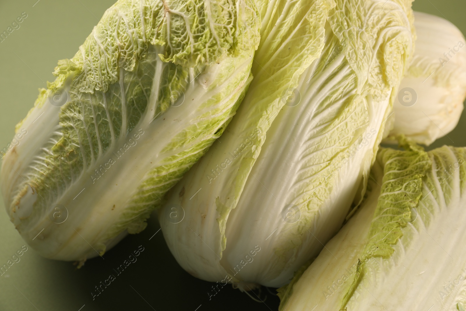 Photo of Fresh ripe Chinese cabbages on olive background, closeup