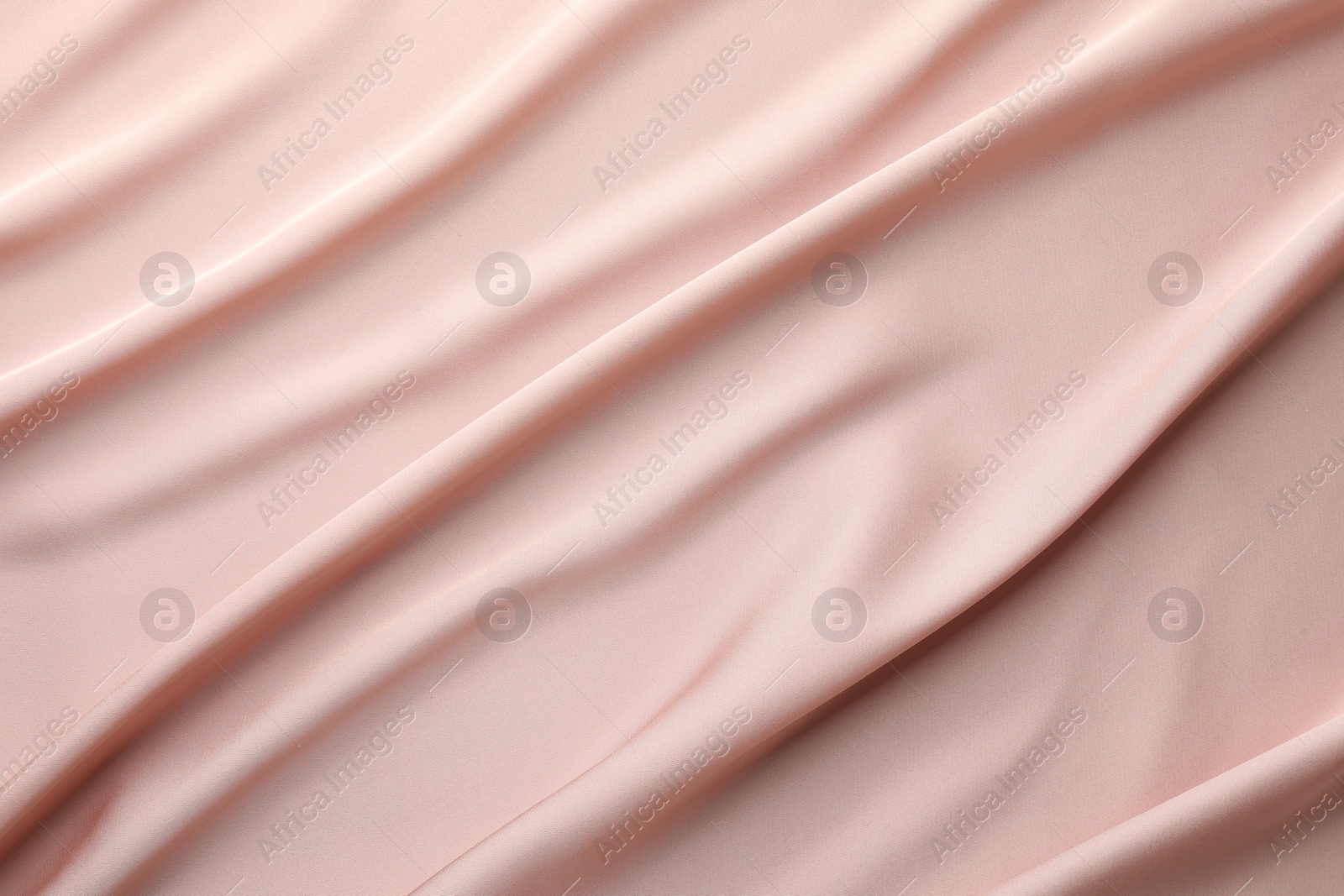 Photo of Crumpled pink silk fabric as background, top view