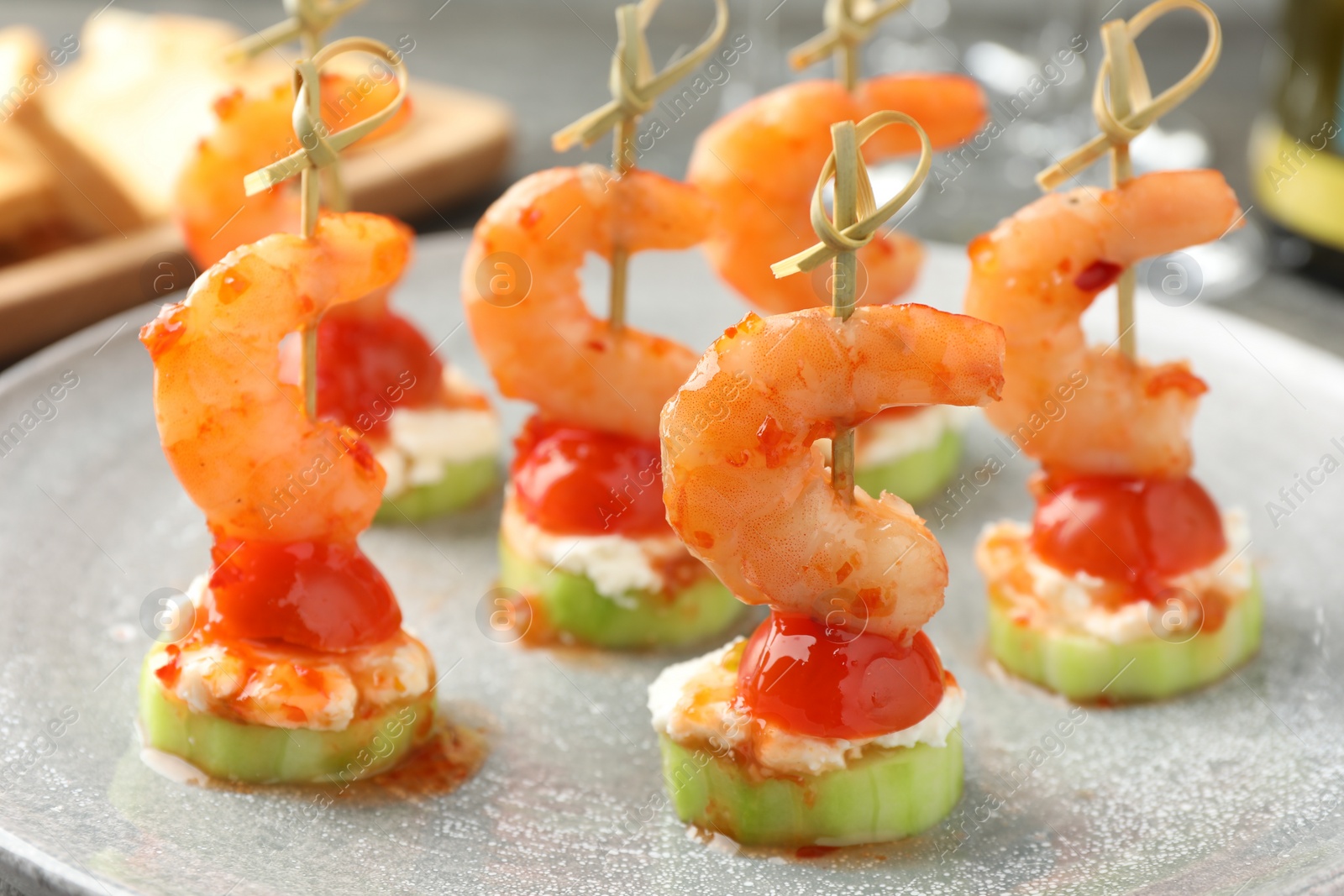 Photo of Tasty canapes with shrimps, vegetables and cream cheese on table, closeup