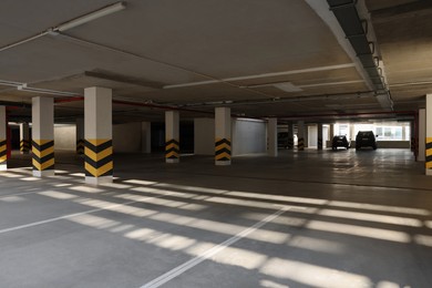 Open parking garage with cars on sunny day