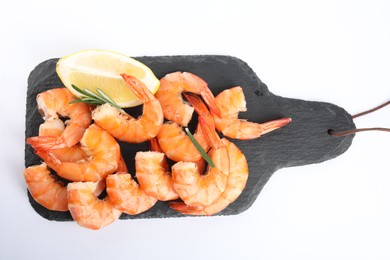 Photo of Delicious cooked shrimps served with lemon and rosemary on white background, top view