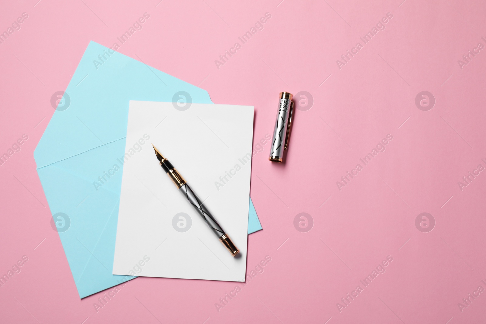 Photo of Blank sheet of paper, letter envelope and pen on pink background, top view. Space for text